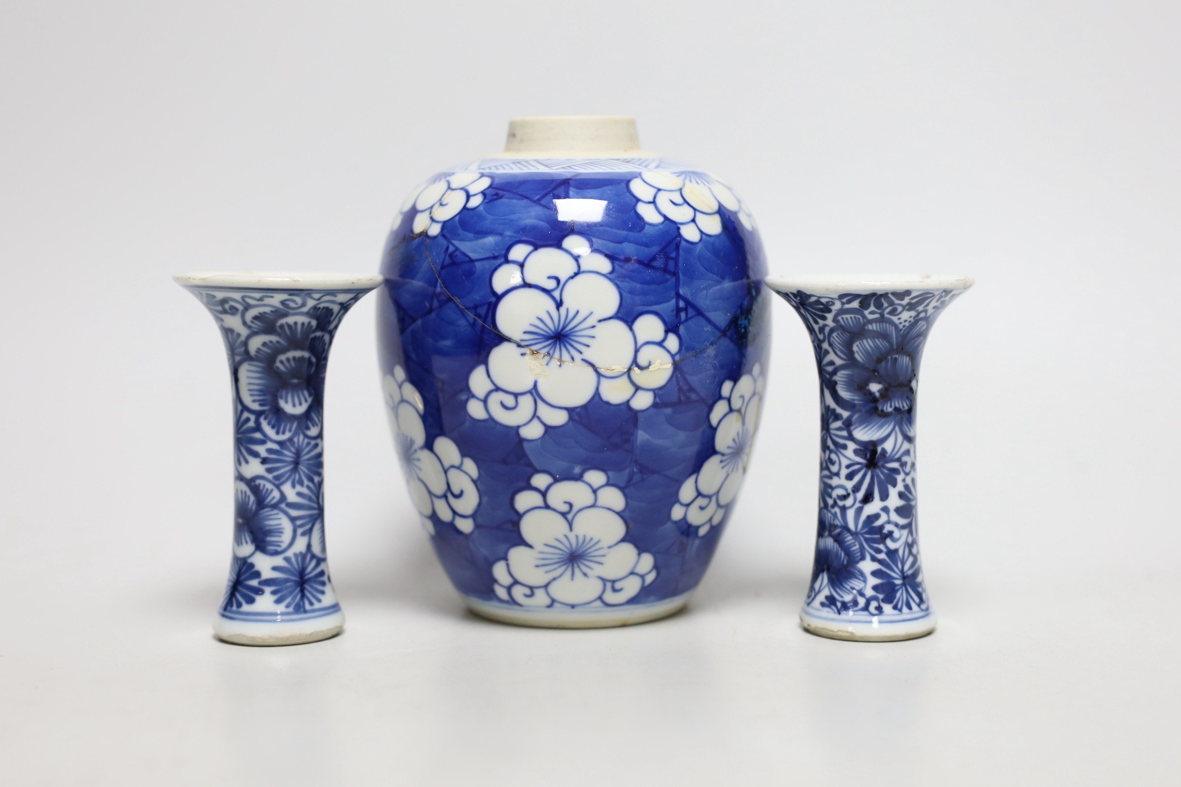 A Chinese blue and white prunus jar, two miniature vases and a dish, all Kangxi period, jar 14cms high